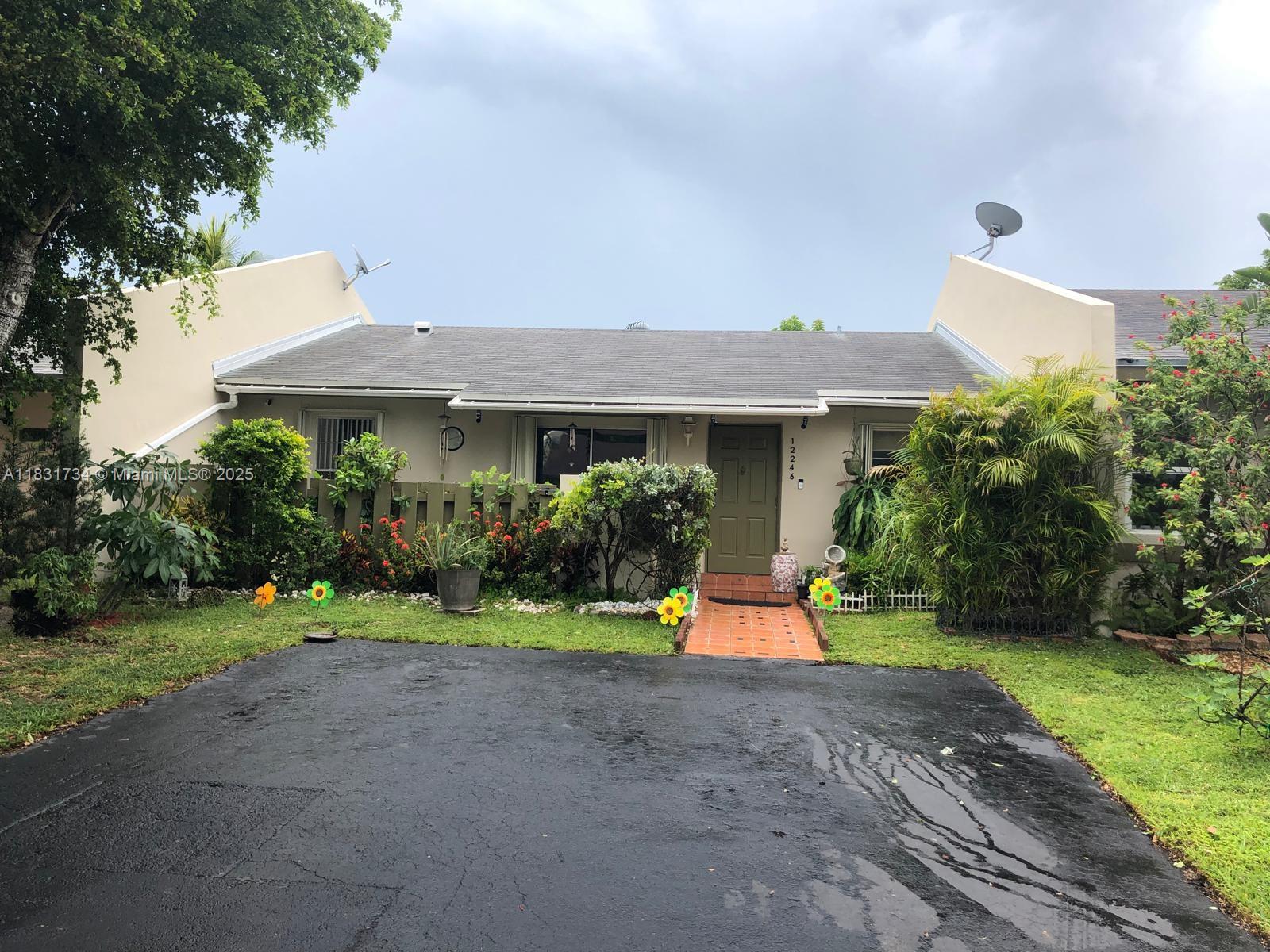 12246 Southwest 116th Lane Miami, FL 33186 - Photo 21 of 23 a front view of a house with swing and a yard