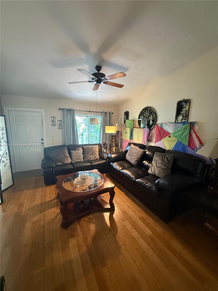 12246 Southwest 116th Lane Miami, FL 33186 - Photo 5 of 23 a living room with furniture and a chandelier