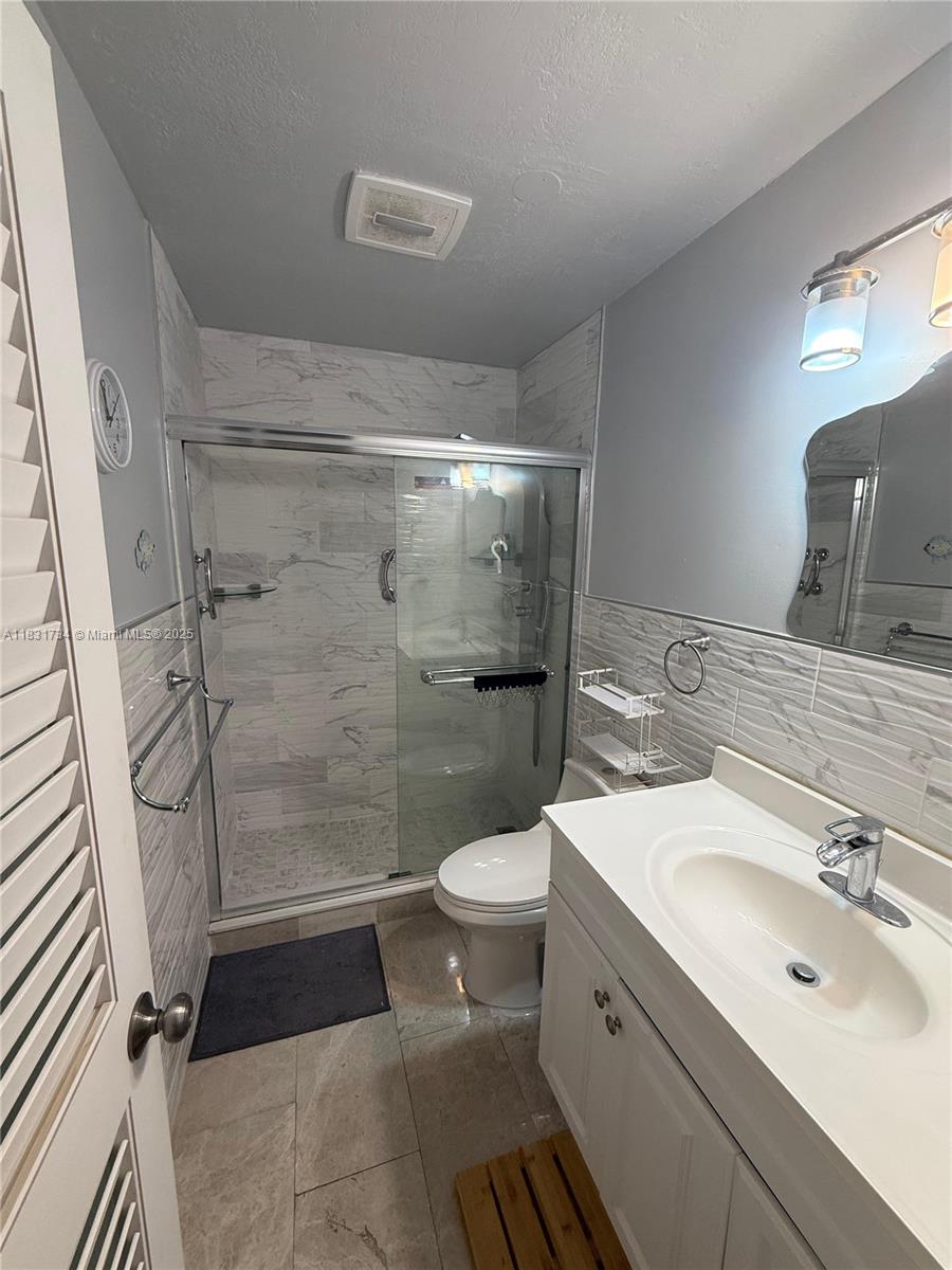 12246 Southwest 116th Lane Miami, FL 33186 - Photo 7 of 23 a bathroom with a sink toilet and shower