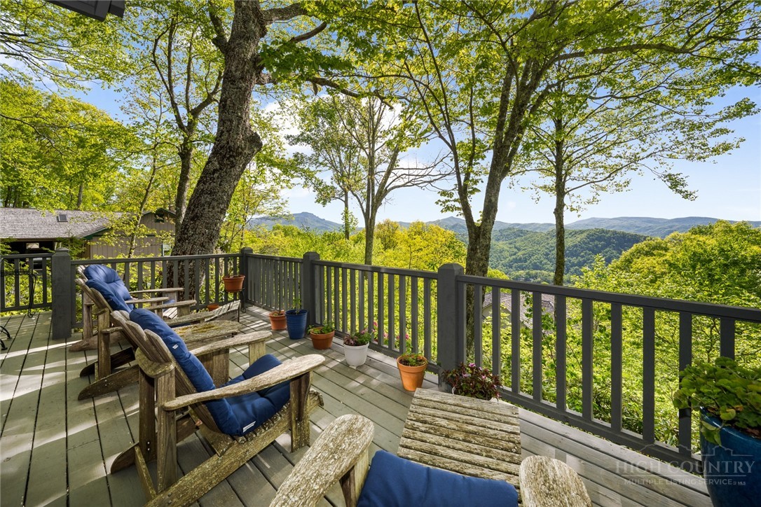 246 Mulberry Lane Boone, NC 28607 - Photo 11 of 49 a view of a balcony with chairs and wooden fence