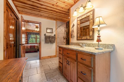 105 Double Branch Trail Murphy, NC 28906 - Photo 50 of 75 a bathroom with a granite countertop sink and a mirror