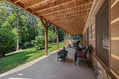 105 Double Branch Trail Murphy, NC 28906 - Photo 61 of 75 a view of a patio with table and chairs and floor to ceiling window