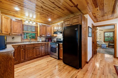 105 Double Branch Trail Murphy, NC 28906 - Photo 69 of 75 a kitchen with stainless steel appliances granite countertop a refrigerator and wooden cabinets