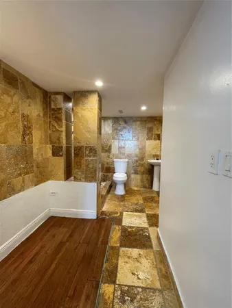 a bathroom with a bathtub and a shower