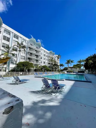 a swimming pool with outdoor seating and yard
