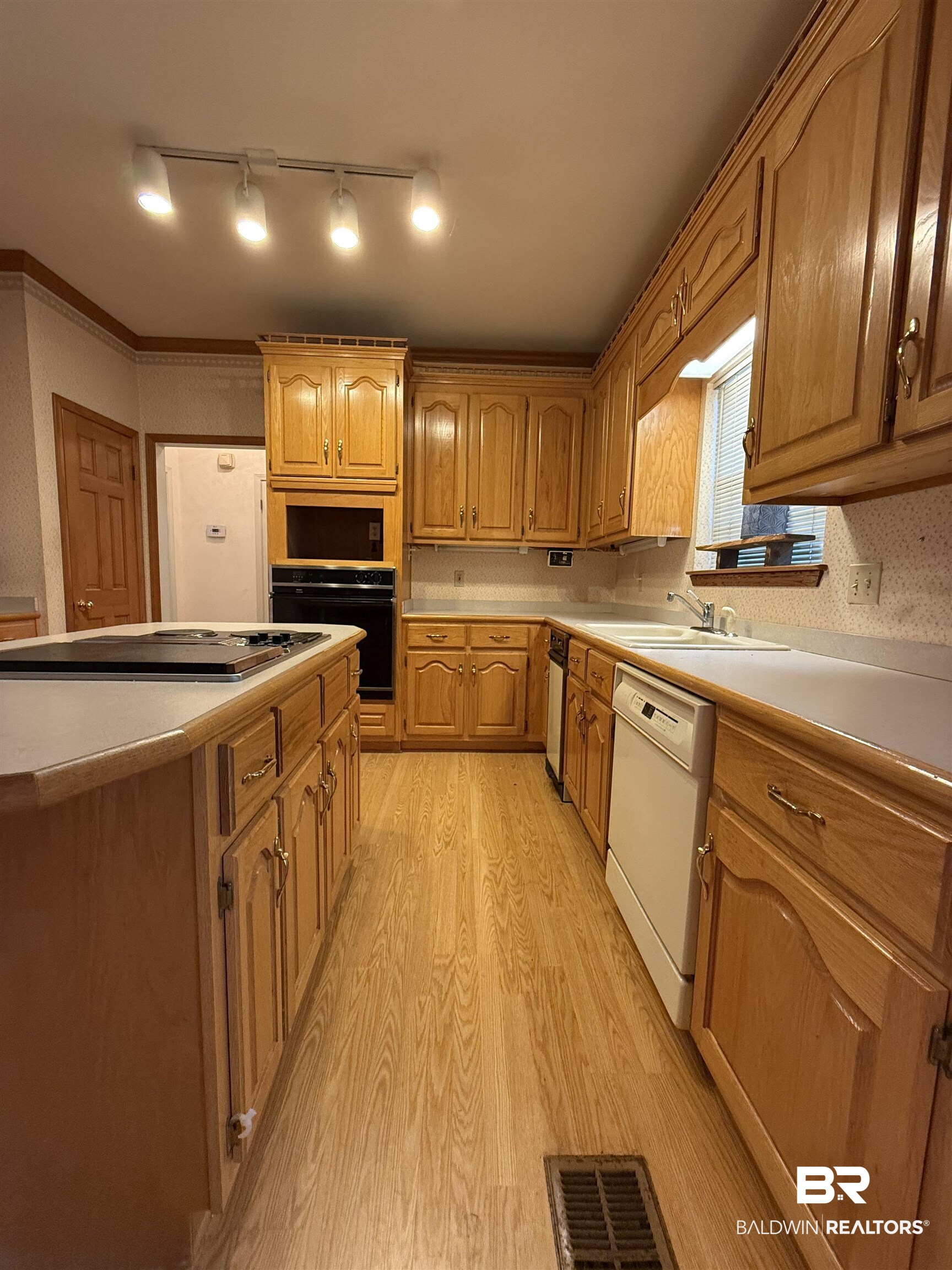 295 Norwood Road Monroeville, AL 36460 - Photo 5 of 32 Kitchen featuring white dishwasher, black oven, a sink, stovetop, and light wood-style floors