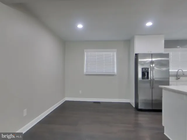 a view of a refrigerator in kitchen and wooden floor