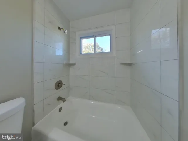 a white bath tub sitting in a bathroom
