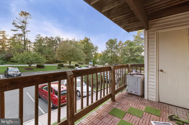 a view of a street with wooden stairs and bench