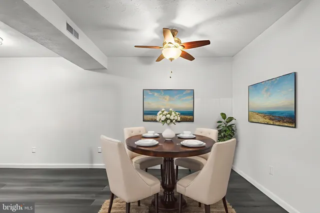 a view of a dining room with furniture and wooden floor