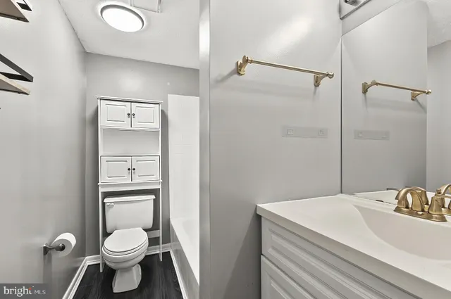 a bathroom with a toilet sink and shower