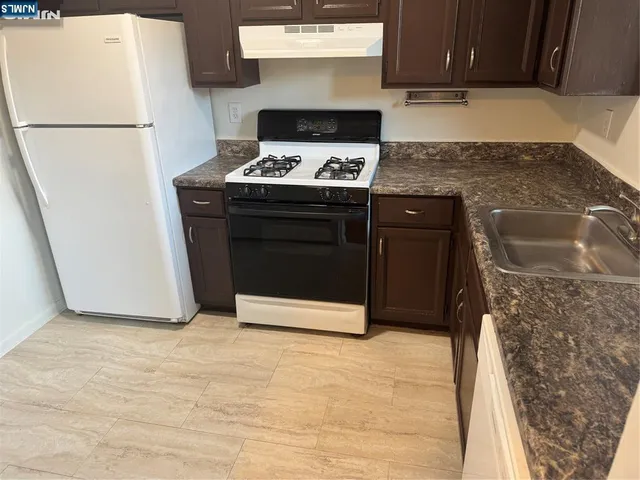 a kitchen with a stove and a refrigerator