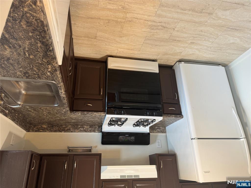 107 Bellgrove Drive, Unit 5A Mahwah, NJ 07430 - Photo 1 of 14 a kitchen with a stove and a refrigerator