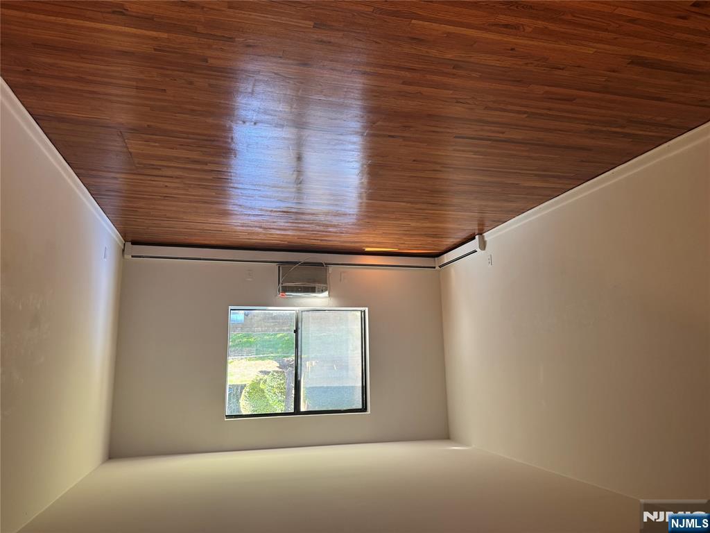 107 Bellgrove Drive, Unit 5A Mahwah, NJ 07430 - Photo 2 of 14 an empty room with wooden floor and windows