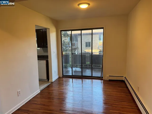 a view of a room with wooden floor