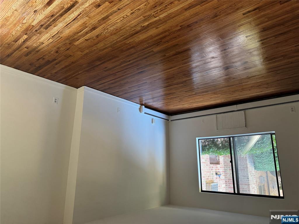 107 Bellgrove Drive, Unit 5A Mahwah, NJ 07430 - Photo 4 of 14 a view of an empty room with wooden floor and a window