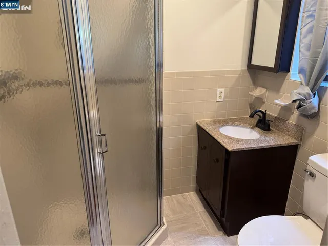 a bathroom with a sink mirror vanity and toilet