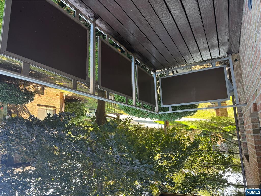 107 Bellgrove Drive, Unit 5A Mahwah, NJ 07430 - Photo 7 of 14 a view of balcony with wooden floor and fence