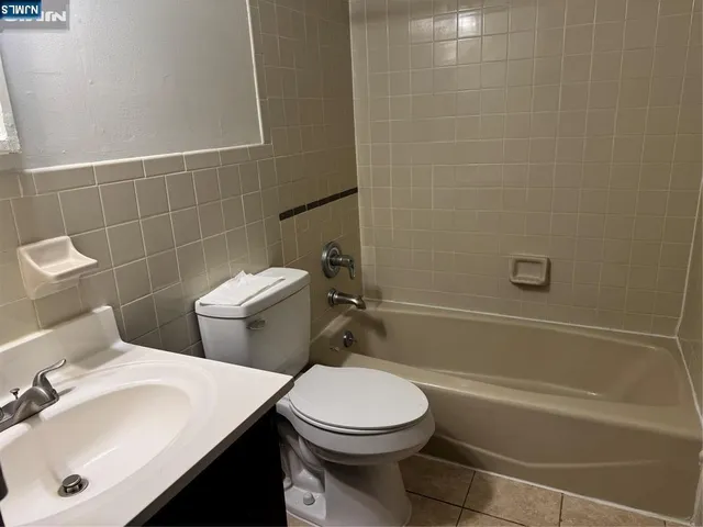 a bathroom with a sink a toilet and a bathtub