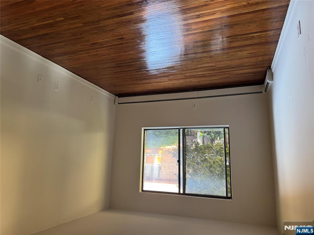107 Bellgrove Drive, Unit 5A Mahwah, NJ 07430 - Photo 9 of 14 a view of an empty room with wooden floor and a window