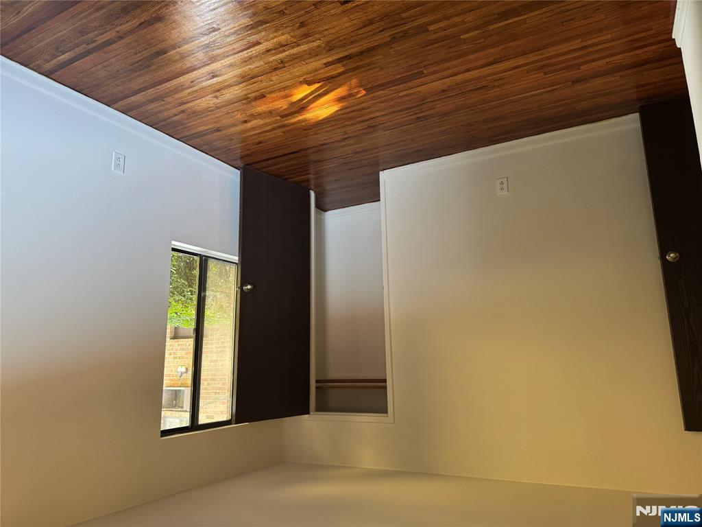 107 Bellgrove Drive, Unit 5A Mahwah, NJ 07430 - Photo 10 of 14 a view of an empty room with wooden floor and a window
