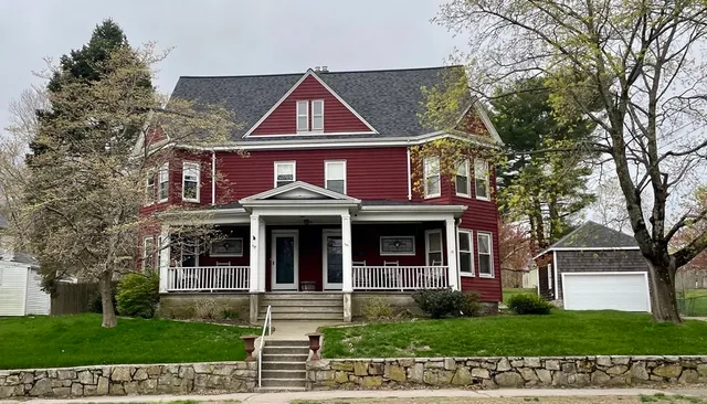 a view of a brick house with a yard