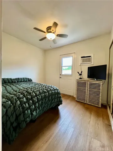 a bedroom with a bed and a view of kitchen