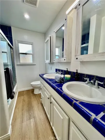a bathroom with a double vanity sink and a mirror