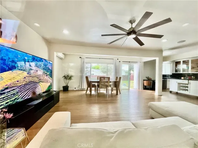 a living room with furniture and a view of kitchen