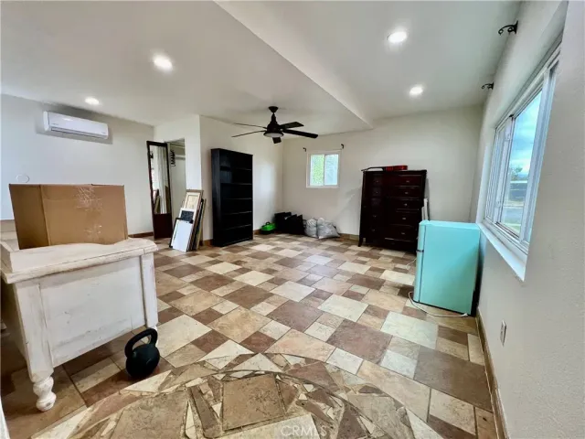 a bedroom with a bed and a chair