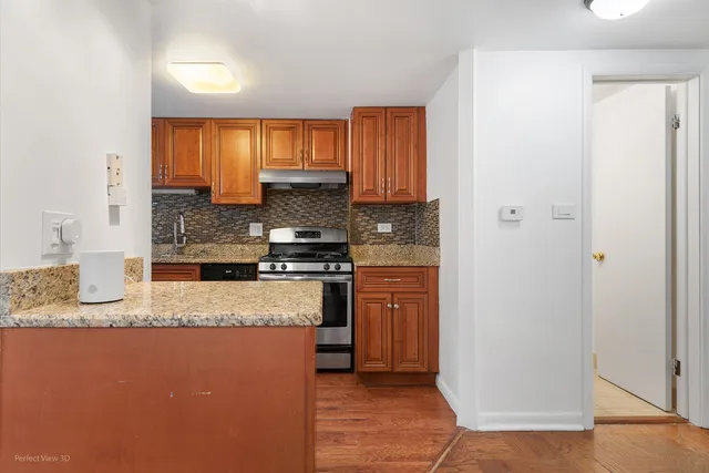 a kitchen with stainless steel appliances granite countertop a refrigerator a stove and a sink