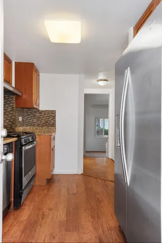 a view of a kitchen with a sink stove and cabinets