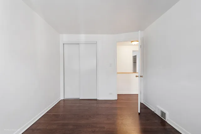 an empty room with wooden floor