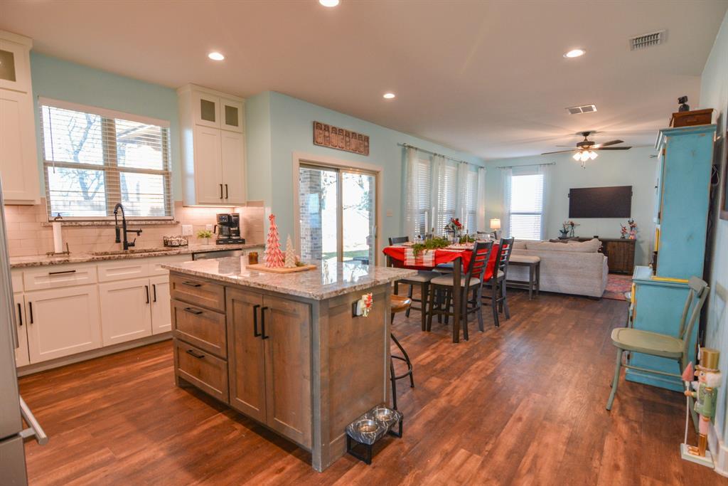 601 Mathew Street Grandview, TX 76050 - Photo 8 of 40 a kitchen with sink cabinets and wooden floor