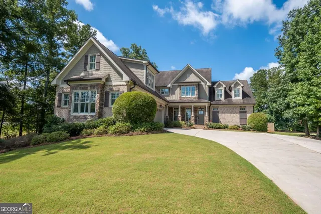 a front view of a house with yard and green space