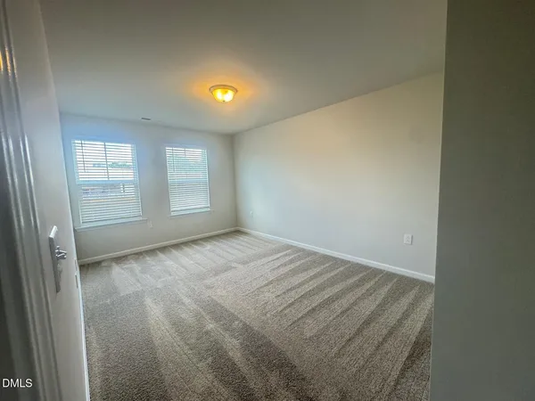 a view of an empty room and a window