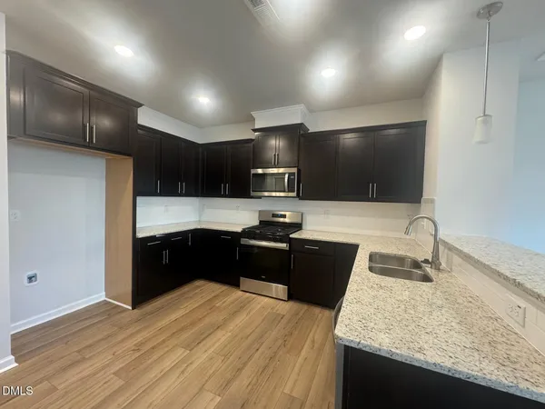 a view of entryway with wooden floor and stairs