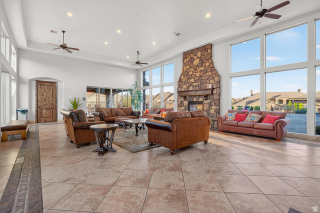 2069 North Coral Ridge Drive Washington, UT 84780 - Photo 32 of 35 Spacious common area featuring a stone fireplace, large format tile flooring, high ceilings with recessed lighting, and multiple ceiling fans
