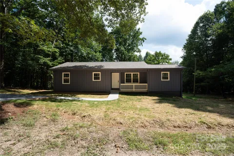 a house that has a tree in front of it