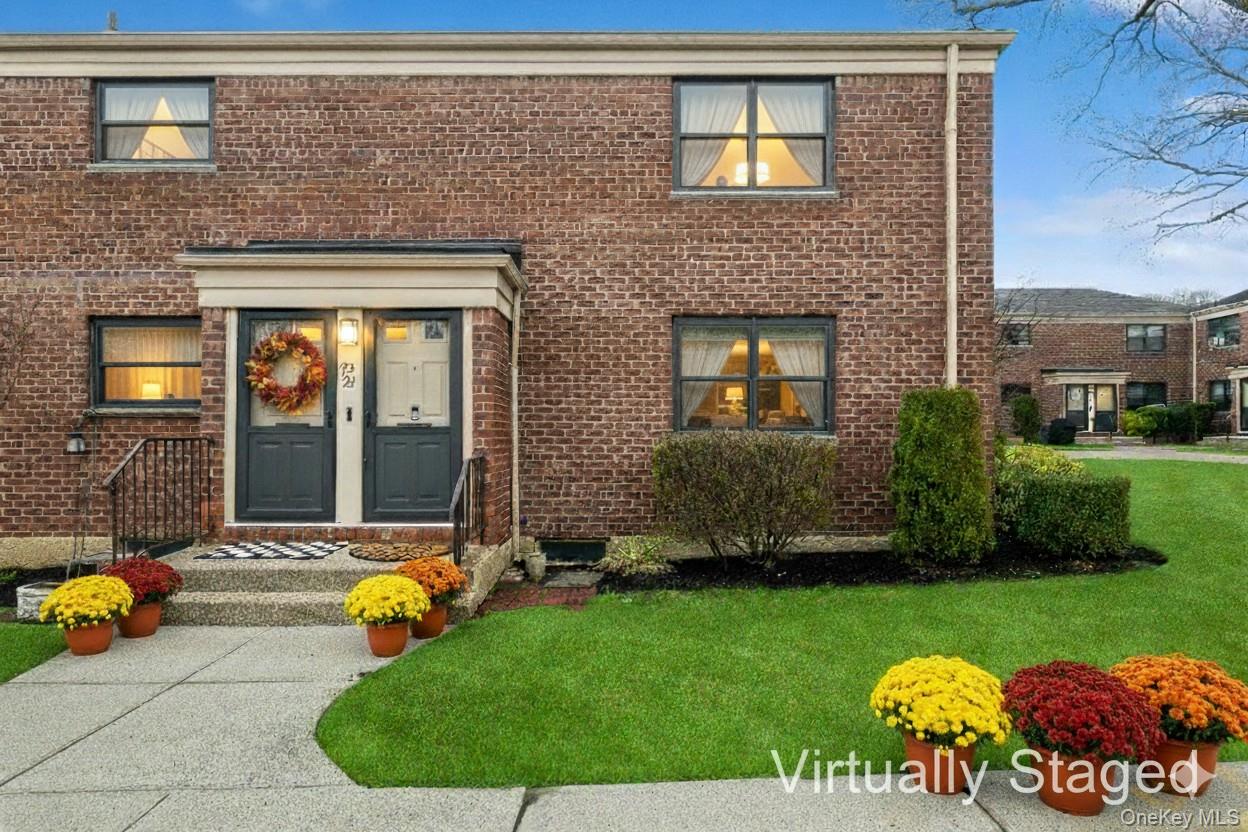 a view of a house with a backyard and patio