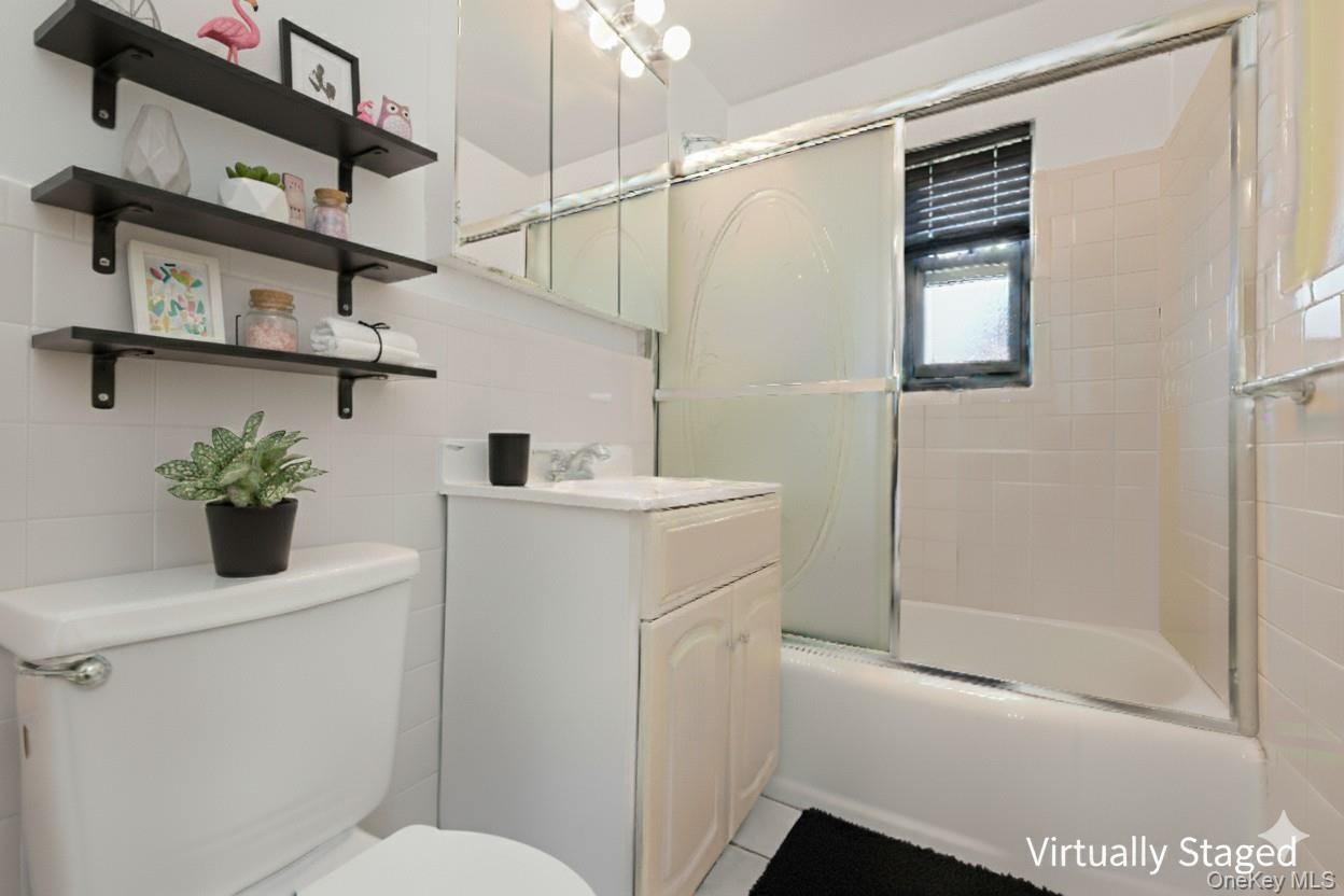 73-21 220th Street, Unit 139B2 Queens, NY 11364 - Photo 11 of 35 a bathroom with a sink a toilet and shower