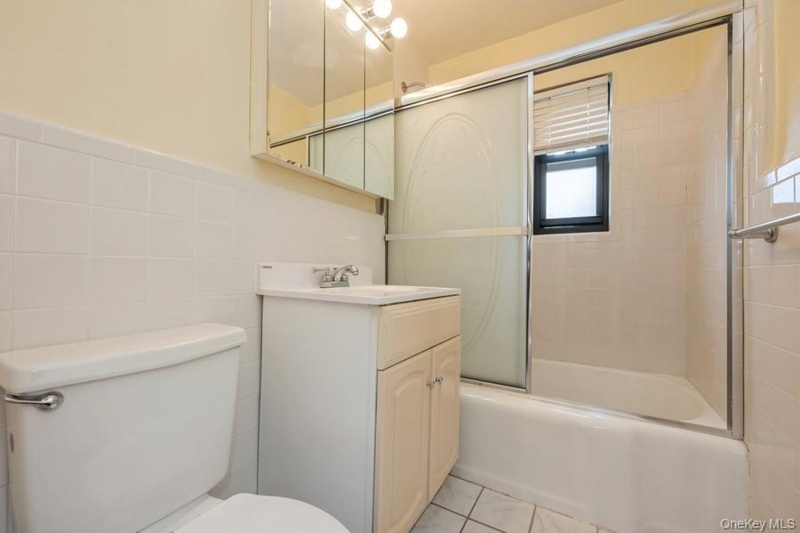 73-21 220th Street, Unit 139B2 Queens, NY 11364 - Photo 12 of 35 a bathroom with a sink a toilet and shower