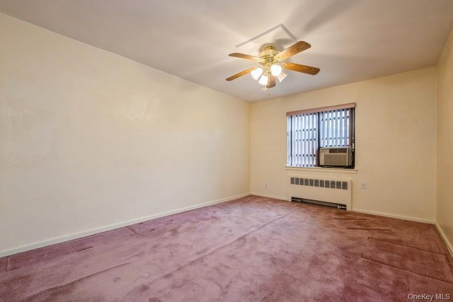 73-21 220th Street, Unit 139B2 Queens, NY 11364 - Photo 14 of 35 an empty room with windows and fan