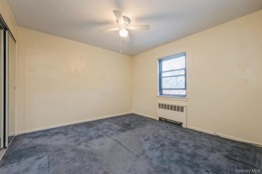 73-21 220th Street, Unit 139B2 Queens, NY 11364 - Photo 17 of 35 an empty room with windows and ceiling fan