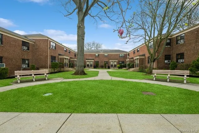 a front view of a building with garden