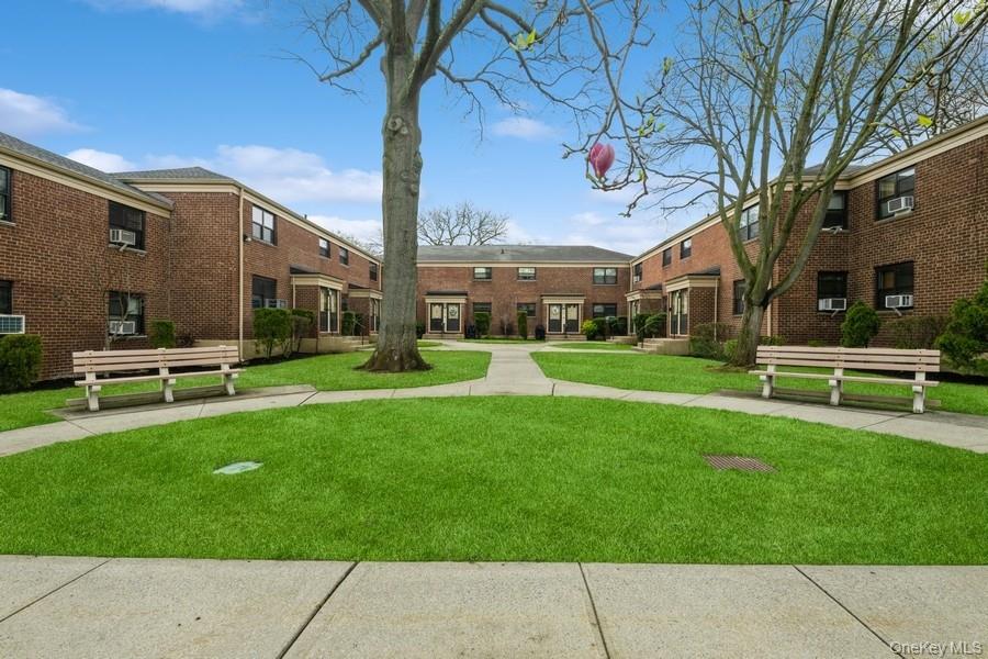 73-21 220th Street, Unit 139B2 Queens, NY 11364 - Photo 22 of 35 a front view of a building with garden