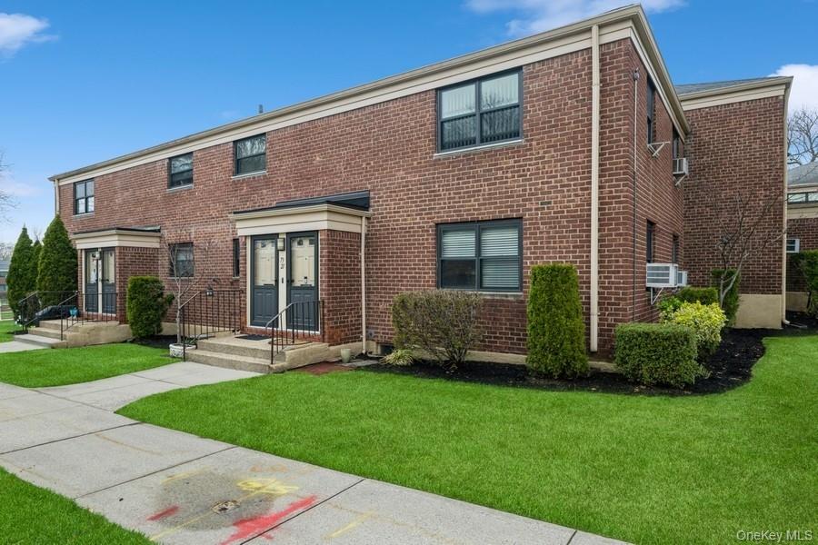 73-21 220th Street, Unit 139B2 Queens, NY 11364 - Photo 25 of 35 a front view of a house with garden and porch