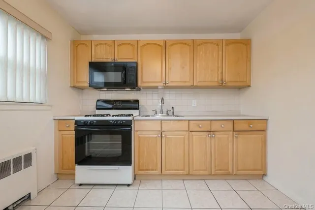 a kitchen with granite countertop white cabinets stainless steel appliances and a sink