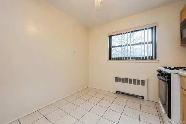 a view of a livingroom with an empty space and a window