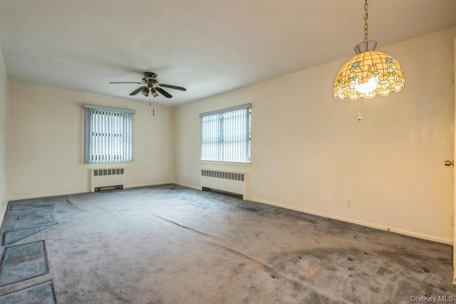 73-21 220th Street, Unit 139B2 Queens, NY 11364 - Photo 6 of 35 an empty room with windows and ceiling fan